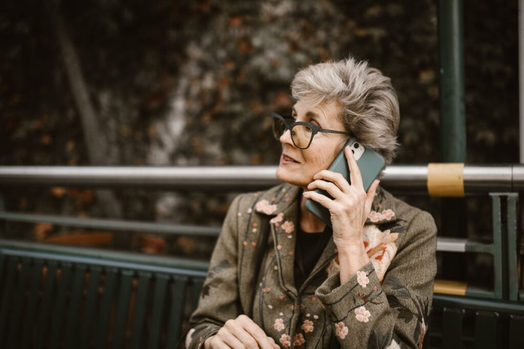 Senior woman talking on her smartphone outdoors