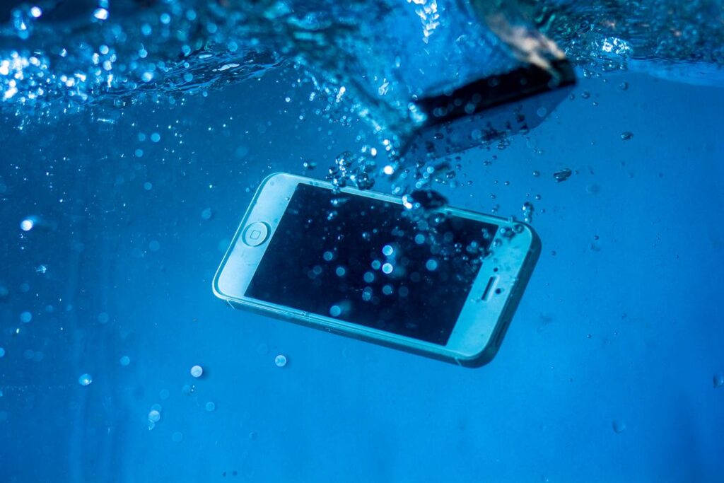 Rugged Everyday 5G Phones With IP64 to IP69 Protection Smartphone splashing into clear blue water