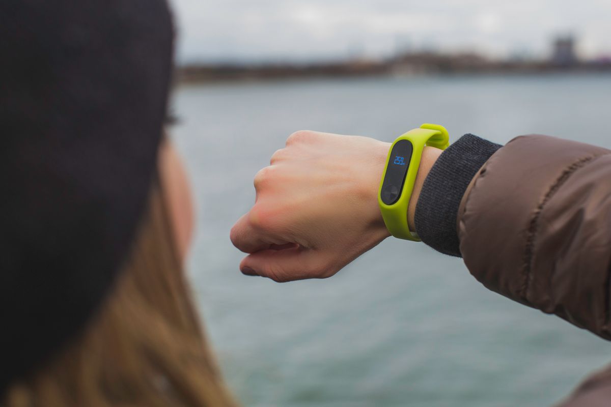 Person checking a fitness smartwatch on the wrist